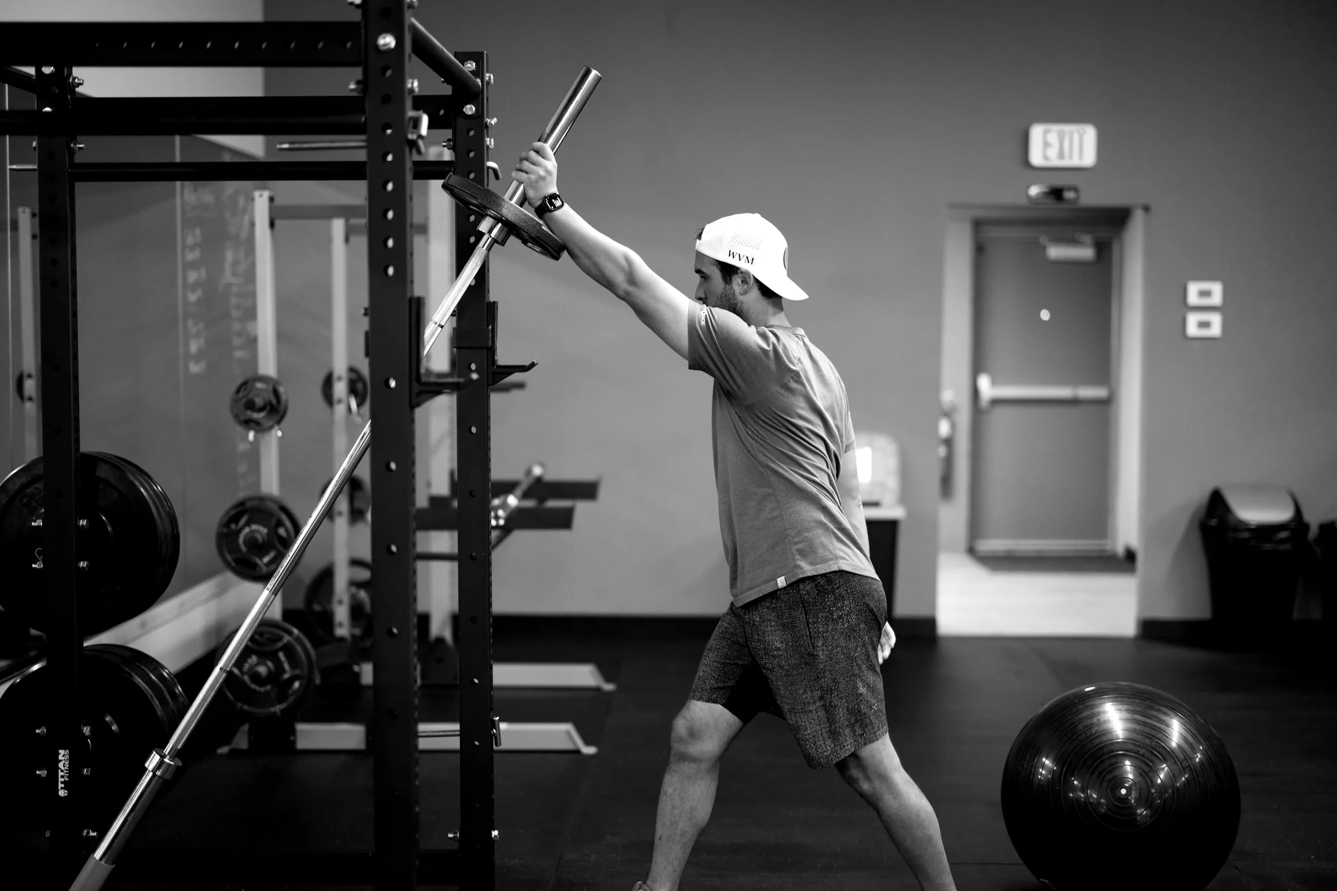 A client training with a landmine press at the DANNOFIT gym in Madison Heights